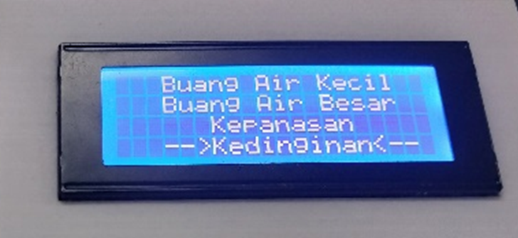 A white device with a screen and wires

Description automatically generated