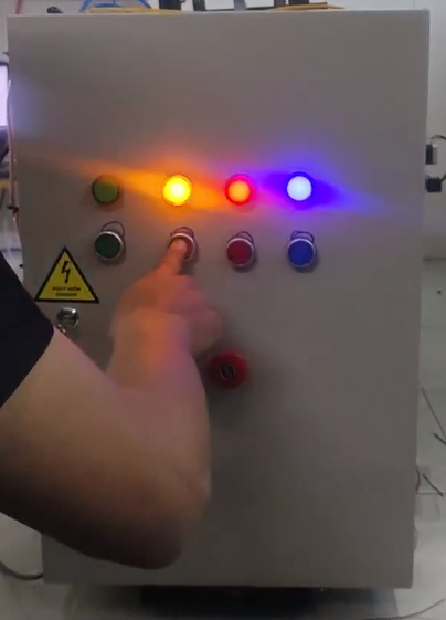 A person pressing a button on a control panel

AI-generated content may be incorrect.
